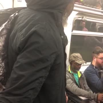 Guy singing god bless america on subway