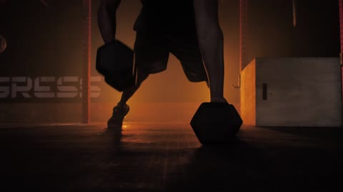 Man doing push ups using dumbbells