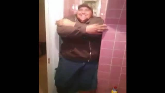 Man Struggles To Sit On Toilet