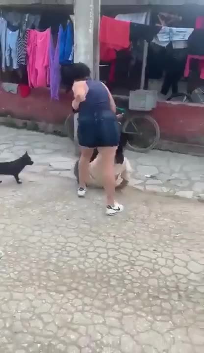 The wife grabs her husband's side piece. But why does she take her anger out on the woman? ?