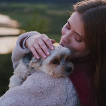 Beautiful woman With A Cute Dog On Her Shoulders video