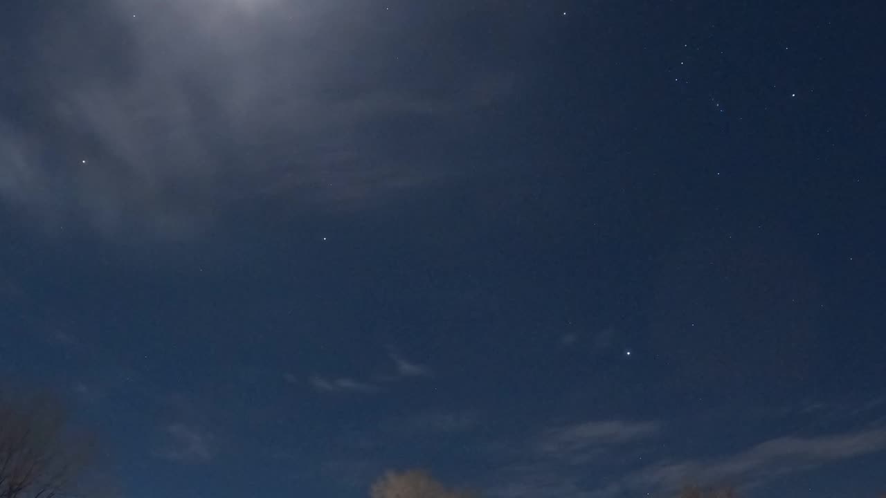 Stars and clouds moving across the sky.