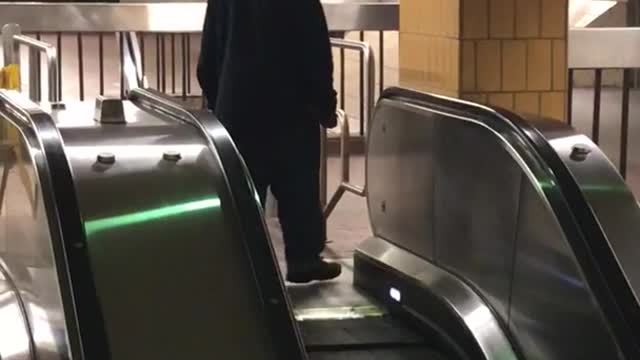 Guy keeps trying to walk down up escalator