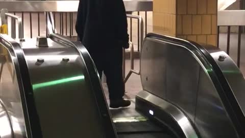 Guy keeps trying to walk down up escalator