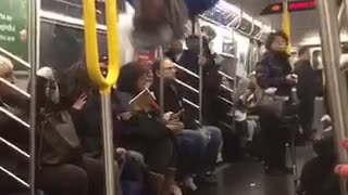 Guy in blue shirt back flip hanging from ceiling