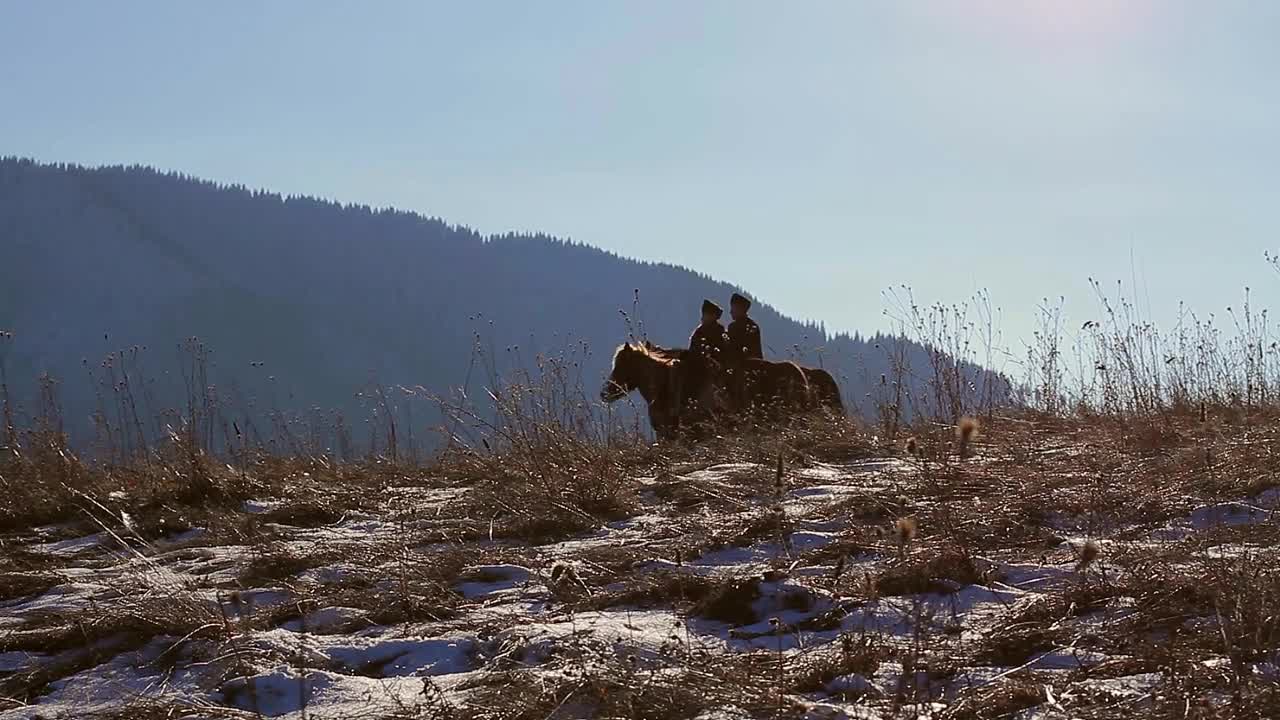 Two border guards on horses during the winter. Sunny winter day