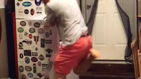 Man in grey pranked with fake snake on floor