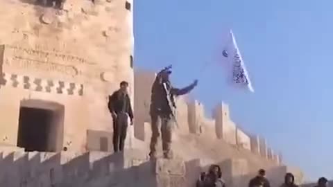 Western-Supported al Qaeda Terrorist Waving Flag at Aleppo Citadel