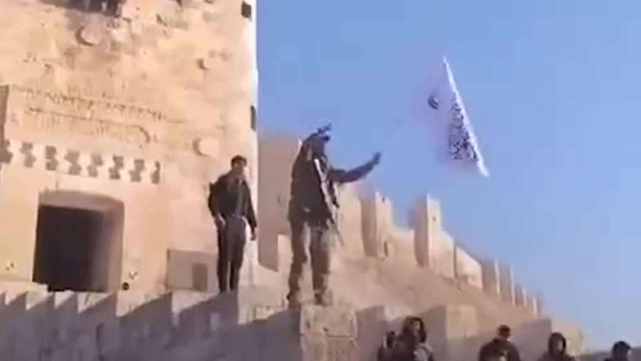 Western-Supported HTS/al Qaeda Terrorist Waving Flag at Aleppo Citadel