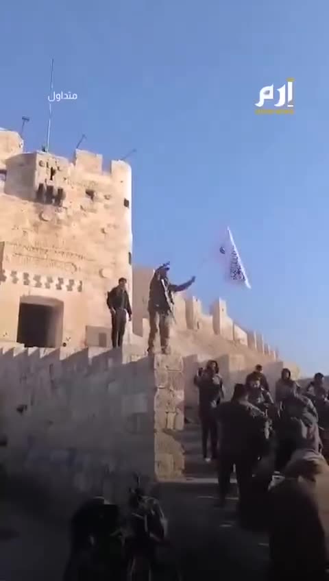 Western-Supported HTS/al Qaeda Terrorist Waving Flag at Aleppo Citadel