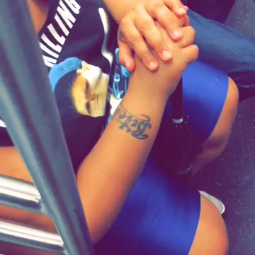 Girl on subway has bitch tattoo on arm