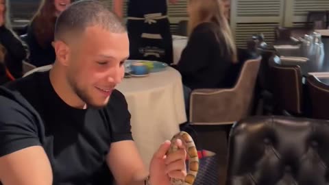 The magician turned the girl's handkerchief into a 🐍