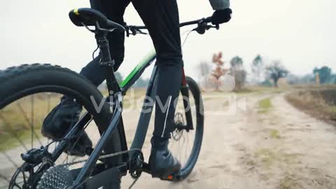 Cyclist Riding A Mountain Bike Down The Road In The Countryside