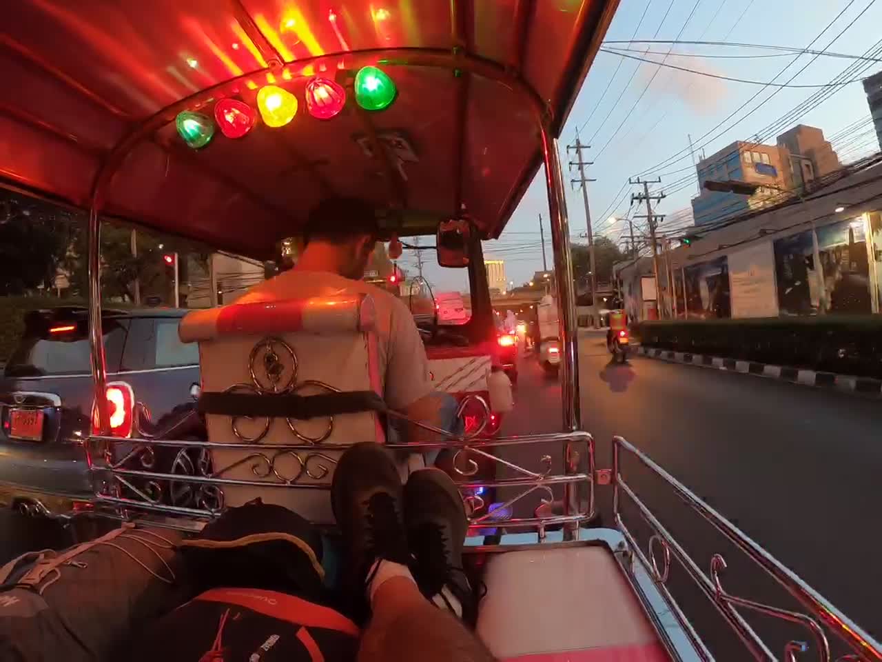 Tuk Tuk ride through Bangkok city in the evening traffic.