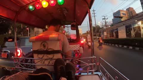 Tuk Tuk ride through Bangkok city in the evening traffic.