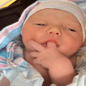 Adorable baby sucks finger