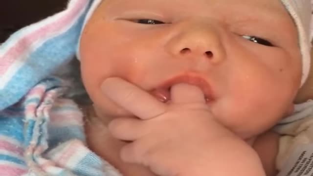 Adorable baby sucks finger