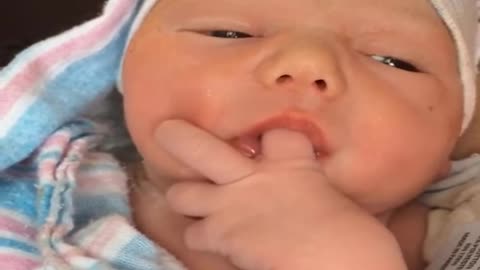 Adorable baby sucks finger