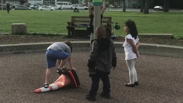 Kids Helping Each Other out at a Playground