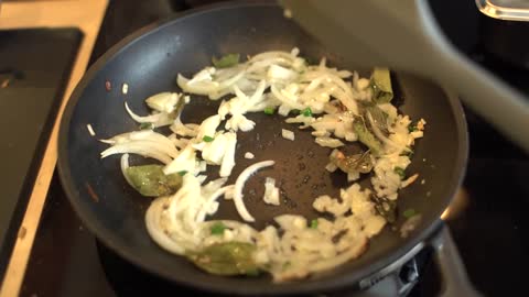 Close Up Shot of Female Hands Stirring Sliced White Onion