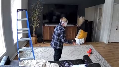 Kid Shoots His Mom With Nerf Gun While Painting