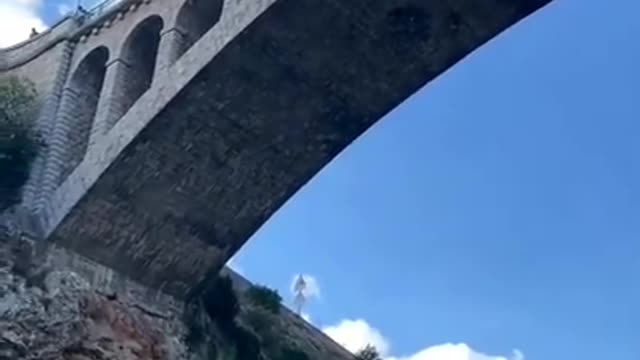 Cliff Diver Dives From Pont Neuf In France