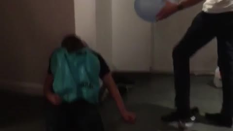 Guy pop balloon drunk friend