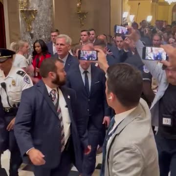 Kevin McCarthy being escorted out of the Speaker office.