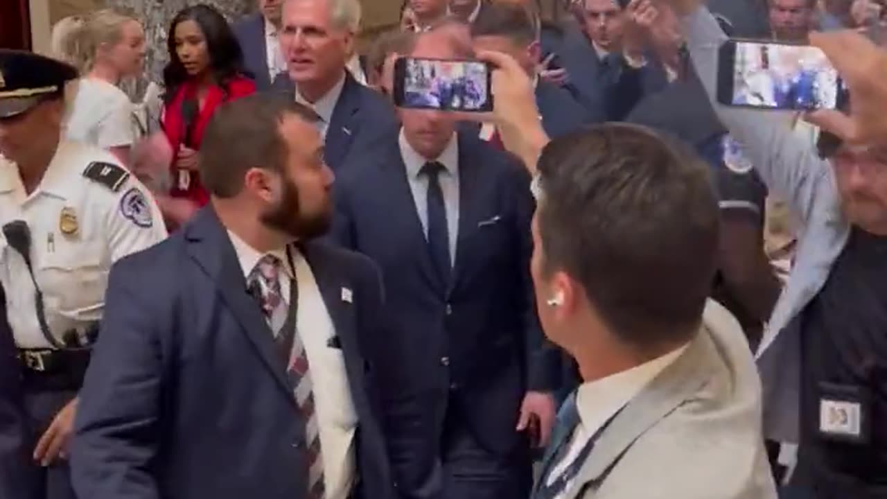 Kevin McCarthy being escorted out of the Speaker office.