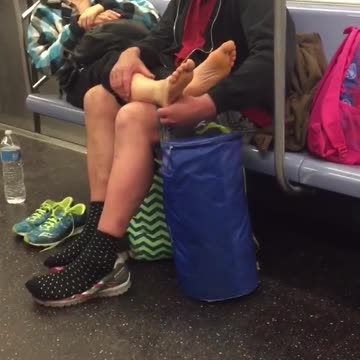 Red shirt black jacket guy foot massage subway lady