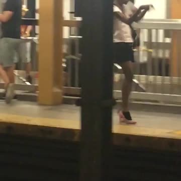 Person subway dancing red high heels splits platform
