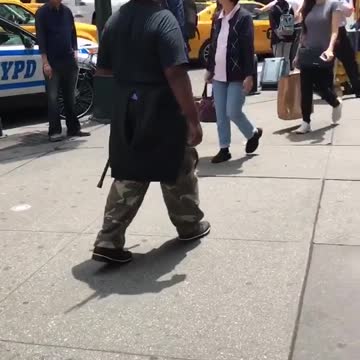 New york legend birdman walks around sidewalk