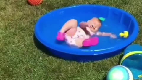 Small girl baby playing with water