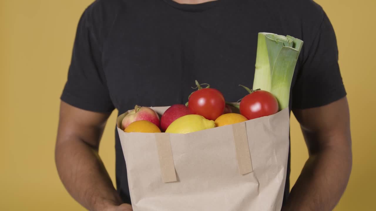 Close Up Shot of Man Holding Bag of Fruit and Vegetables