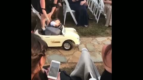 Child sleeps in the toy car at the time of the ceremony.