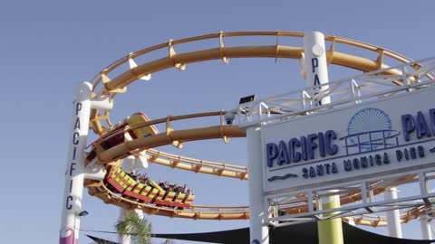 Blue sky and white clouds and a roller coaster