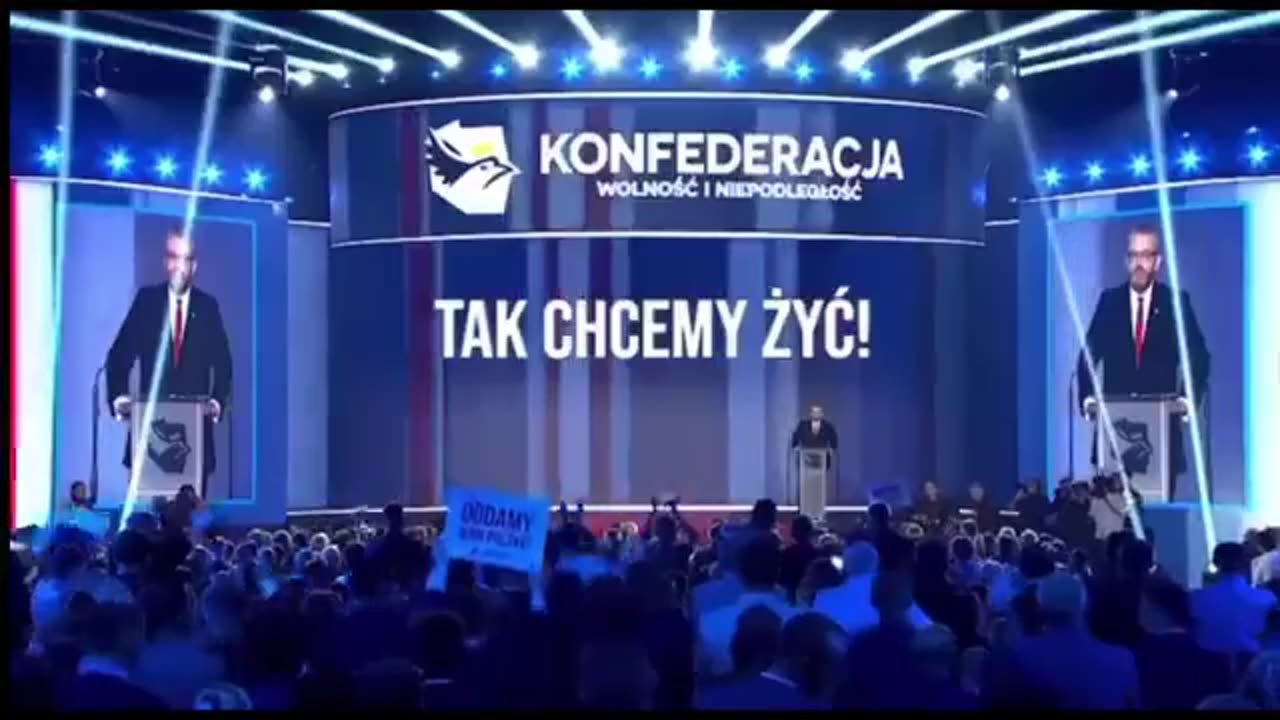 Grzegorz Braun gives a speech to a cheering crowd