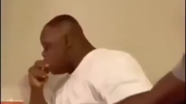 Black man falls off chair