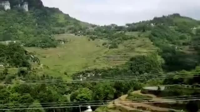 The countryside and fields surrounded by mountains