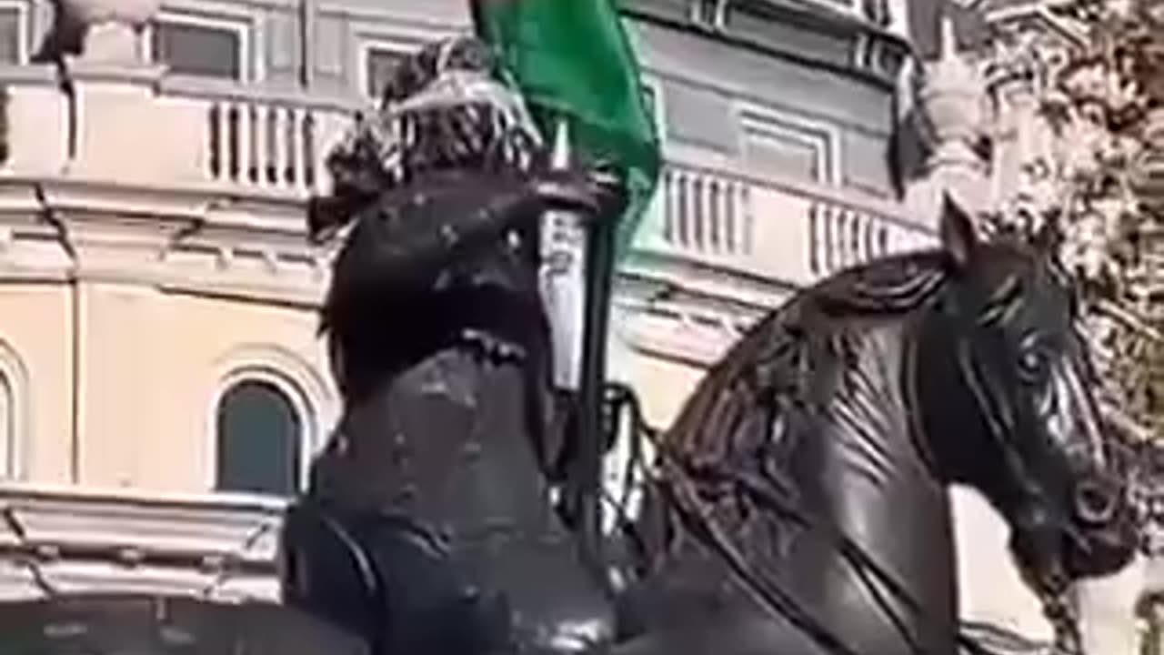 Protesters in London with Palestinian flag on a statue of King Charles I