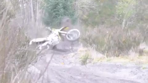 Green dirtbike tries to take corner faceplants into ground