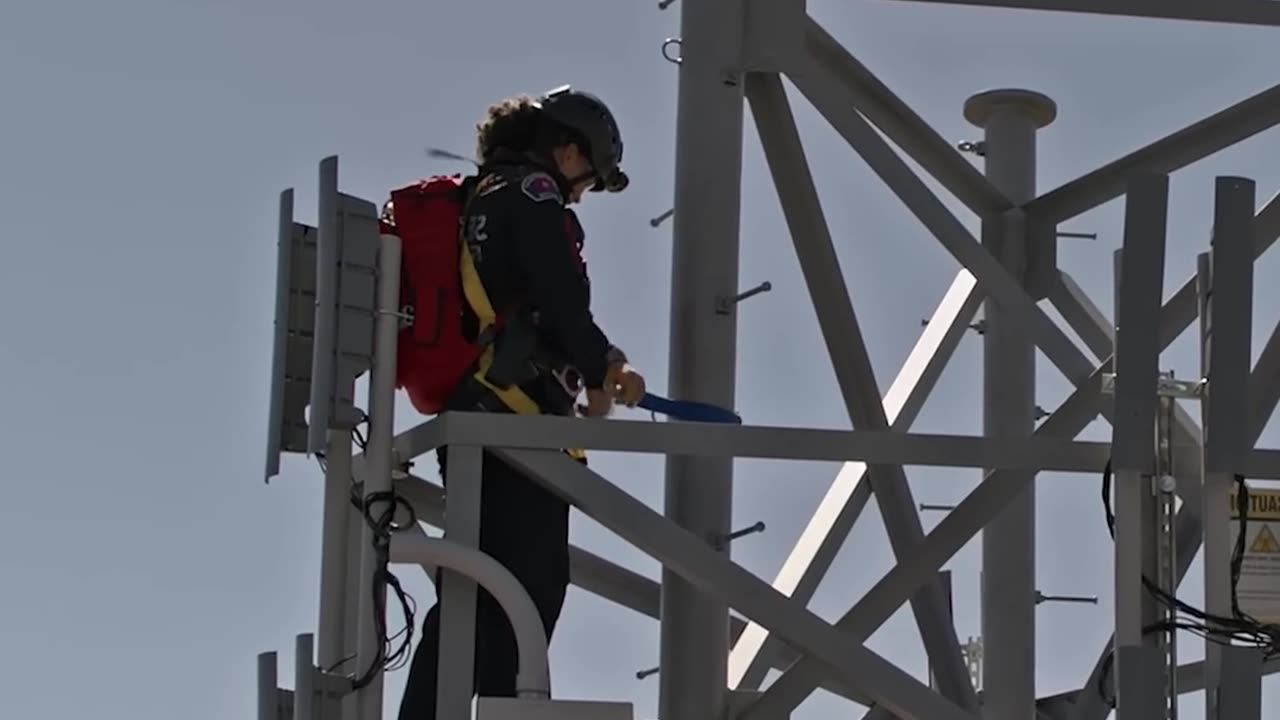 Fire brigade rescues man standing on electricity pylon