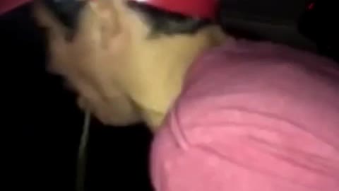 Guy maroon shirt wearing hat and throwing up