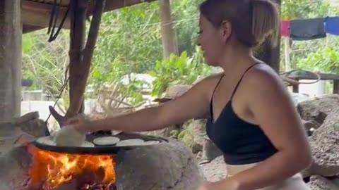 Woman Makes Traditional Gorditas on a Griddle with Beans and Cheese