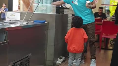 A funny ice cream guy plays with kid