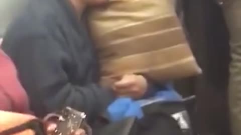 Man sleeps with brown pillow on subway