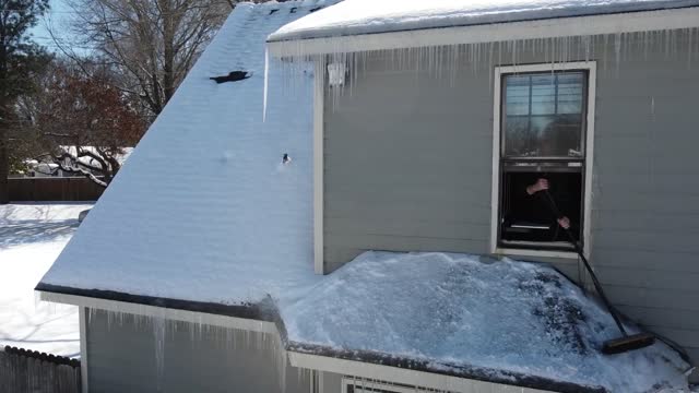 Sweeping snow off the roof