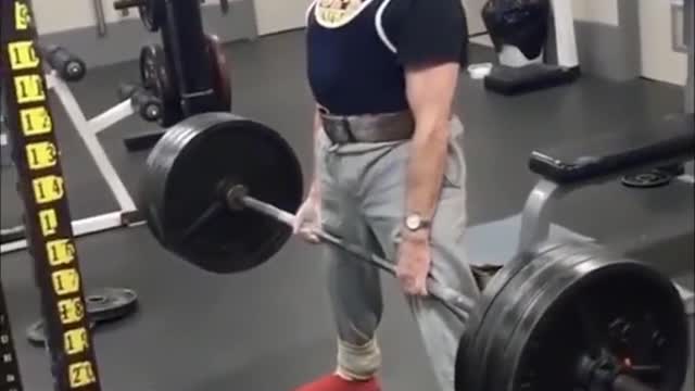 An old man who practices barbell pulling