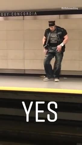 Yes buff headband man dances in subway terminal