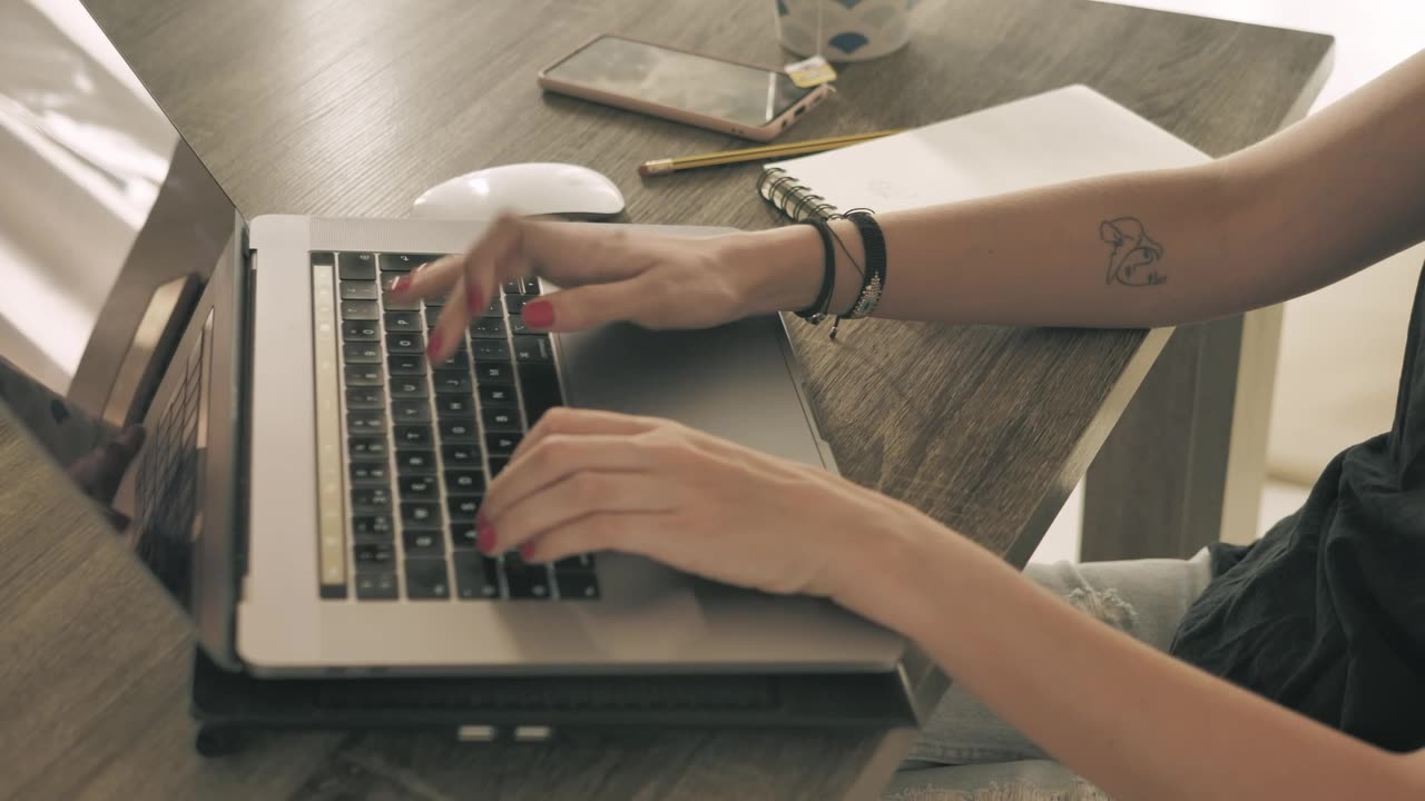 Hands of a girl working on a computer